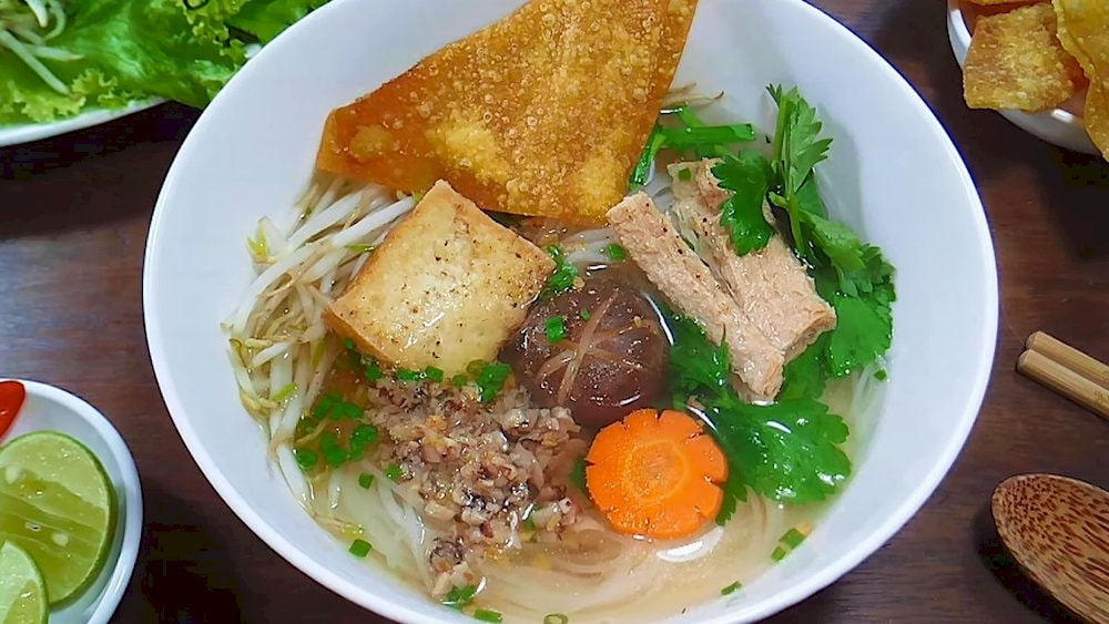 Vegan Hu Tieu with sweet broth, delicious chewy noodles, combined with mushrooms, tofu, and fresh vegetables, creating a delicate flavor